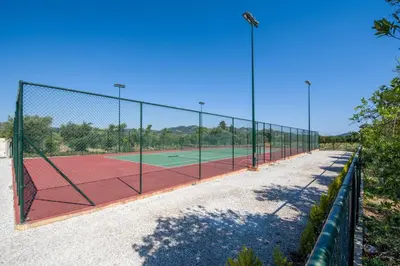 a tennis court with a net on a tennis court at Queen Electra with pool and tennis court in Alikianós