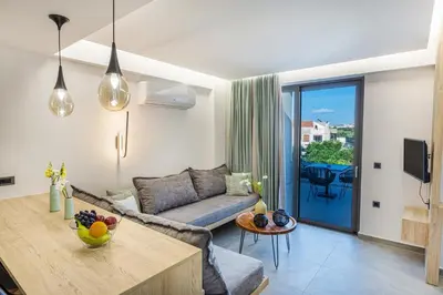 a living room with a couch and a table at Twins Apartments in Plataniás