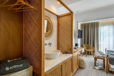 a bathroom with a sink and a mirror at Solimar White Pearl - Adults Only in Kolymvari