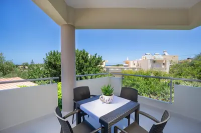 a patio with a table and chairs on a balcony at Alexandra Apartment in Daratso