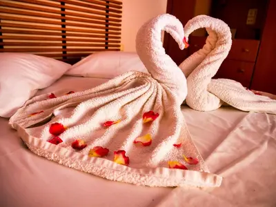 two swans wrapped in towels on a bed at Cosy Apartments Daphne in Daratso