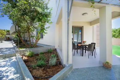 a patio of a home with a table and chairs at Ariadne Apartment in Daratso