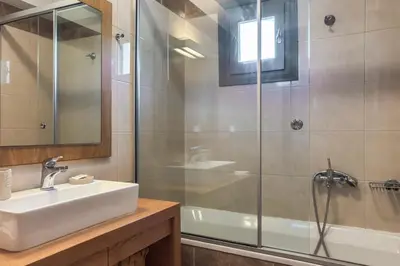 a bathroom with a sink and a shower at YaChara Villa in Kissamos