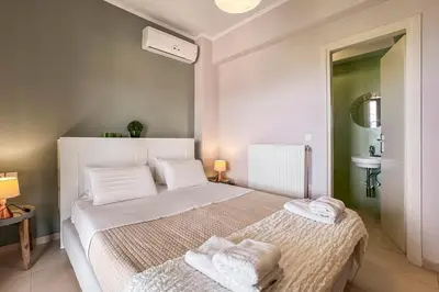 a bedroom with a bed with towels on it at YaChara Villa in Kissamos