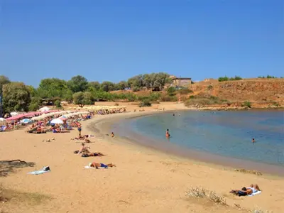 a group of people on a beach near the water at Ellie Apartment in Daratso