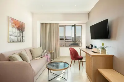 a living room with a couch and a table at M City Hotel in Chania Town