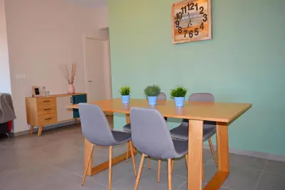 a dining room table with chairs and a wooden table at Balos Residence private pool Seafront Seaview in Kissamos