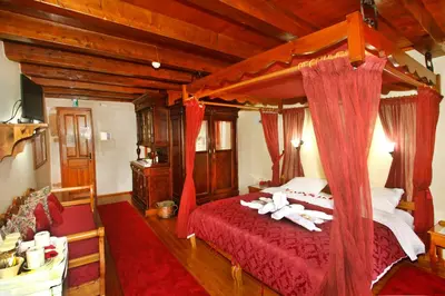 a bedroom with a canopy bed with towels on it at Palazzo di Pietro in Chania Town