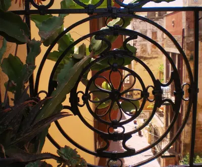a wrought iron fence with a plant on it at Palazzo di Pietro in Chania Town