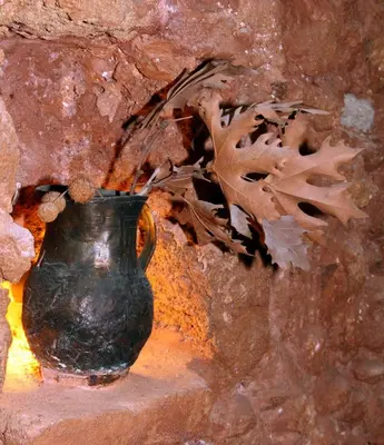 a black vase sitting on a stone wall at Palazzo di Pietro in Chania Town