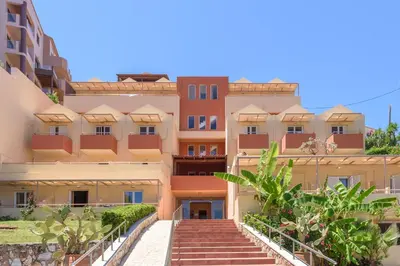 a building with stairs in front of it at Eurohotel Theo Hotel in Agia Marina Nea Kydonias
