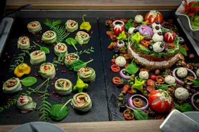 a tray of food with vegetables on a table at Eurohotel Theo Hotel in Agia Marina Nea Kydonias