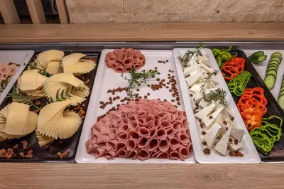 a tray of different types of food on a table at Eurohotel Theo Hotel in Agia Marina Nea Kydonias