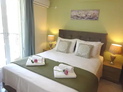 a bedroom with a large bed with towels on it at Marias Apartment in Chania Town