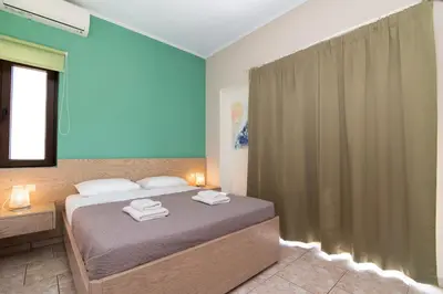 a bedroom with a bed with two towels on it at Dream Sea House villa Falassarna in Falasarna