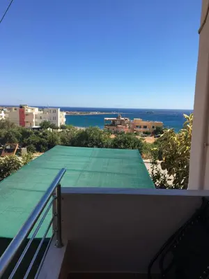 a view from the balcony of a building with a green roof at 180 Degree Sea View Apartment in Palaiochóra