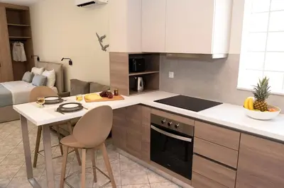 a kitchen with a table and a stove top oven at Superior Central Studio in Chania Town