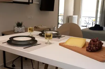 a table with two glasses of wine and cheese on it at Superior Central Studio in Chania Town