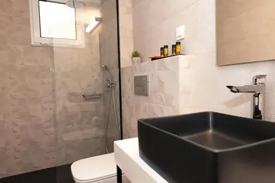 a bathroom with a sink and a toilet and a shower at Superior Central Studio in Chania Town