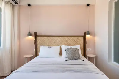 a bedroom with a large bed with two pillows at Artemide city places-Cozy Rooms in Chania Town