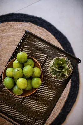 a bowl of limes on a table next to a cactus at Artemide city places-Cozy Rooms in Chania Town