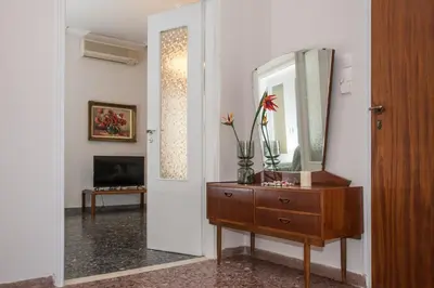 a living room with a dresser and a mirror at The Romantic Beach House in Chania Town
