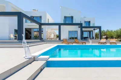 a villa with a swimming pool and a house at Villa Kounoupidiana in Kounoupidhianá