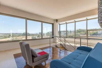 a living room with a blue couch and a chair at Villa Kounoupidiana in Kounoupidhianá