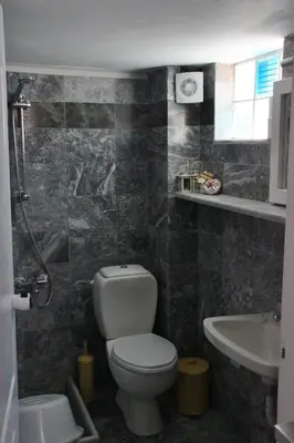 a bathroom with a toilet and a sink at Santa Irene in Sougia