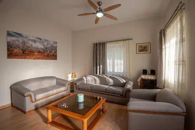 a living room with two couches and a table at Panorama Country Residence in Tzitzifés