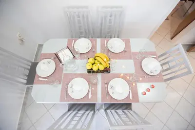 a table with plates and a bowl of fruit on it at Panorama Country Residence in Tzitzifés