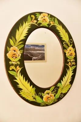 a mirror with a floral design on a wall at Filoxenia Apartments 2 in Palaiochóra