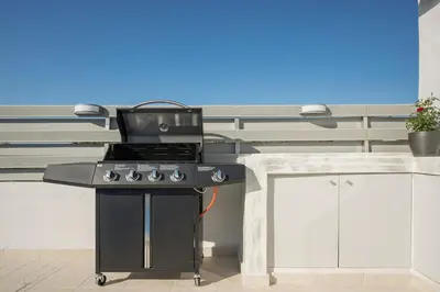 a black grill in a kitchen with a counter at b&m villas in Metókhion Sirilíou