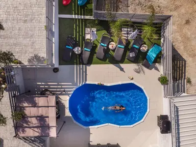 an overhead view of a swimming pool on a building at b&m villas in Metókhion Sirilíou