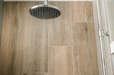 a shower with a shower head in a bathroom at Plaza 1866 Superior City Rooms in Chania Town