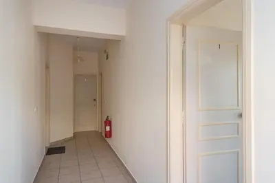 a hallway with a fire hydrant next to a door at Golden Beach Hill Apartments in Kato Daratso