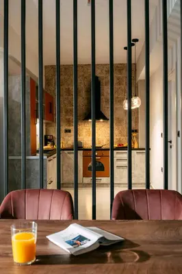 a wooden table with two chairs and a kitchen at Olvini Villa in Galatás
