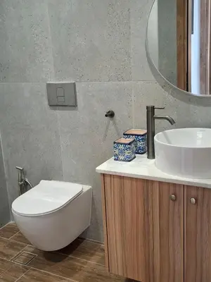 a bathroom with a sink and a toilet and a mirror at Grammeno Seaside Studios in Palaiochóra