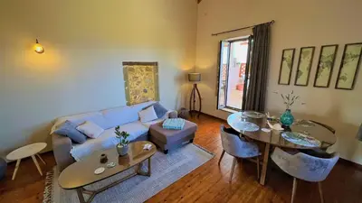 a living room with a couch and a table at Villa Rosemari, Anatoli Apartment in Afráta