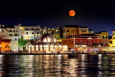 a view of a city at night with a full moon at Chania City Home in Chania Town
