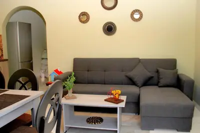 a living room with a couch and a table at Chania City Home in Chania Town