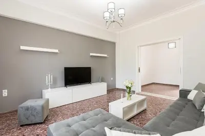 a living room with a couch and a tv at Anemelia in Chania Town