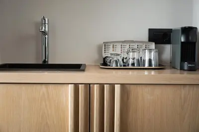 a kitchen counter with a sink and appliances on it at Lignum Suites Chania in Chania Town