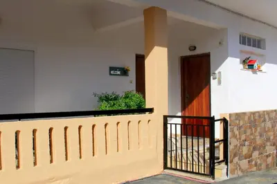 a house with a wooden door and a fence at Chania Dream Home in Chania Town