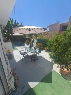 a patio with a table and an umbrella at Chania Dream Home in Chania Town