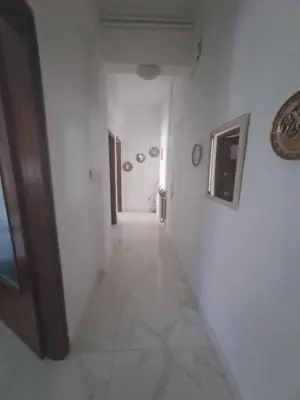 a hallway with white walls and a hallway with a door at Chania Dream Home in Chania Town