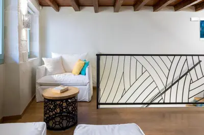 a living room with a white couch and a table at Iosifinas Boutique House in Chania Town
