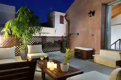 a patio with a couch and a table with candles at Iosifinas Boutique House in Chania Town