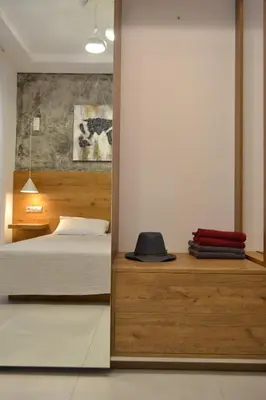 a bedroom with a bed and a hat on a counter at Paraskevi's Apartments in Kissamos