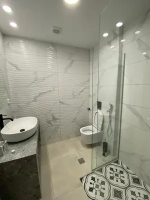 a bathroom with a shower and a toilet and a sink at Paraskevi's Apartments in Kissamos